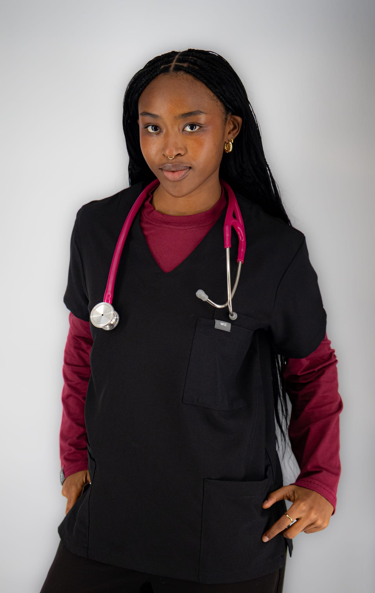 Student in black WiZscrubs with a maroon long-sleeve underscrub