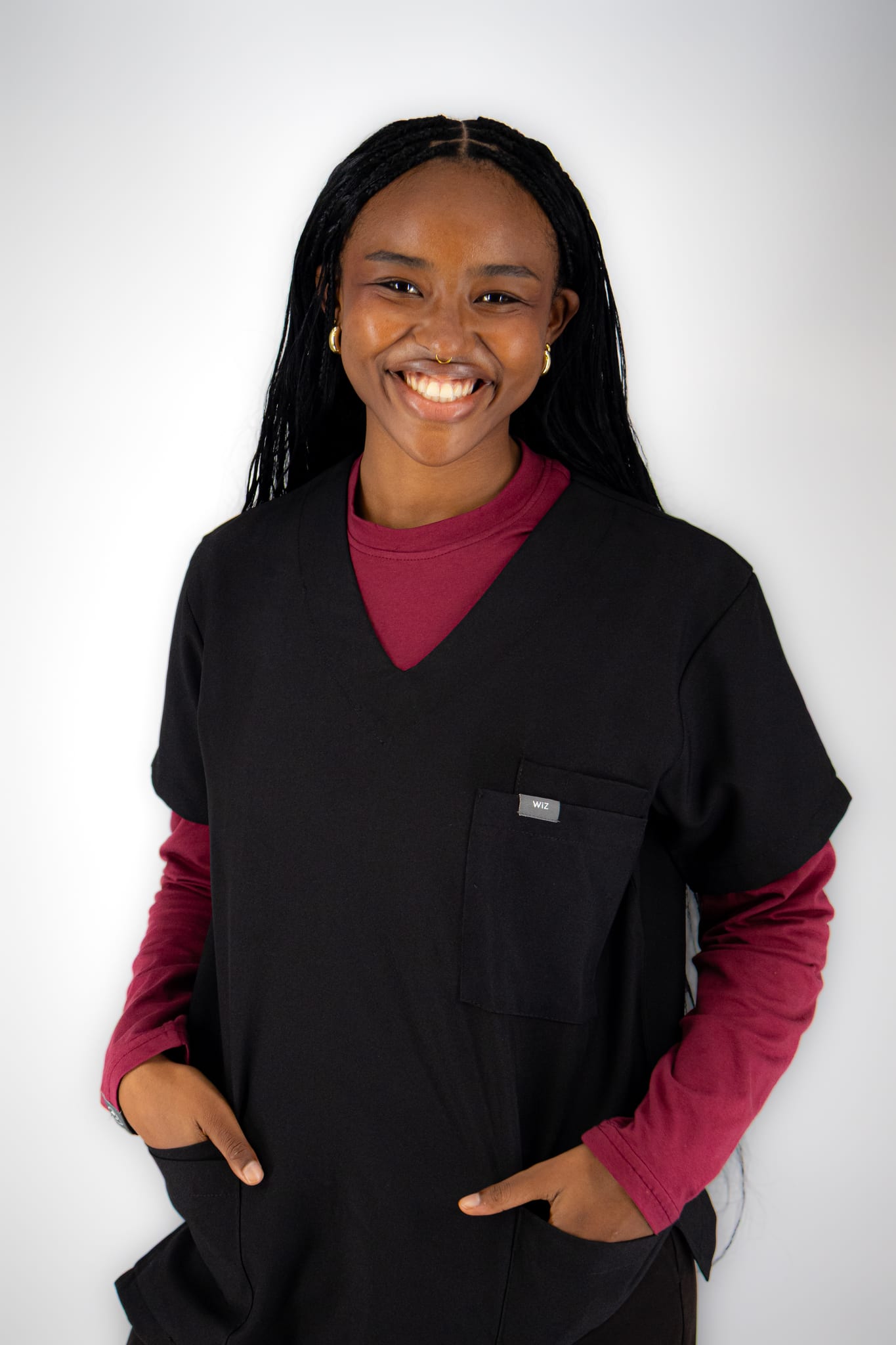Woman in black WiZscrubs over a maroon underscrub