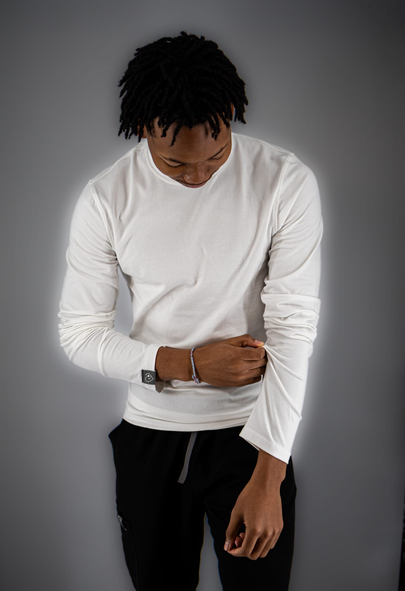 Man wearing a white long-sleeve underscrub