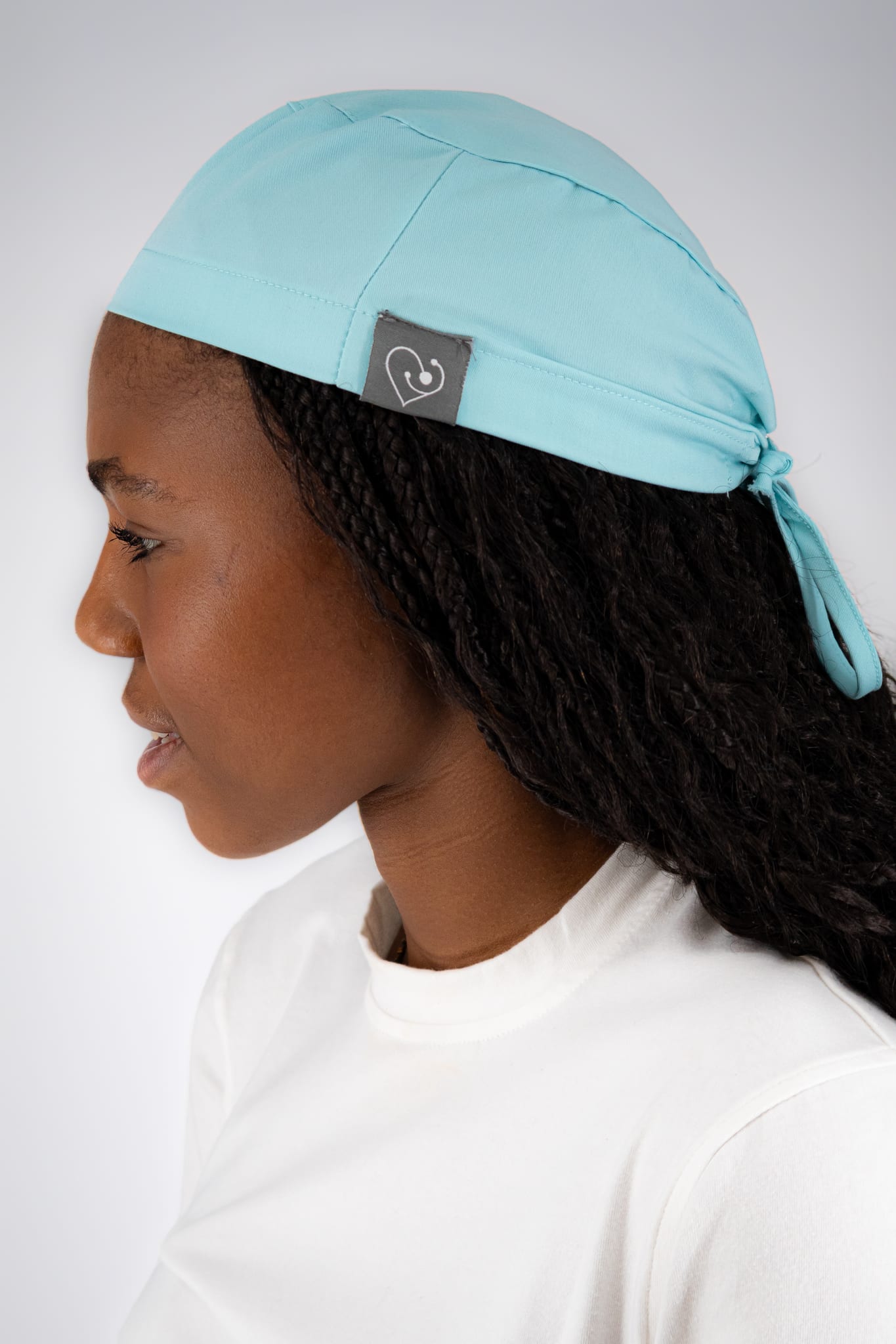 Student wearing an aqua WiZ Scrub Cap Pro with the tie-back visible