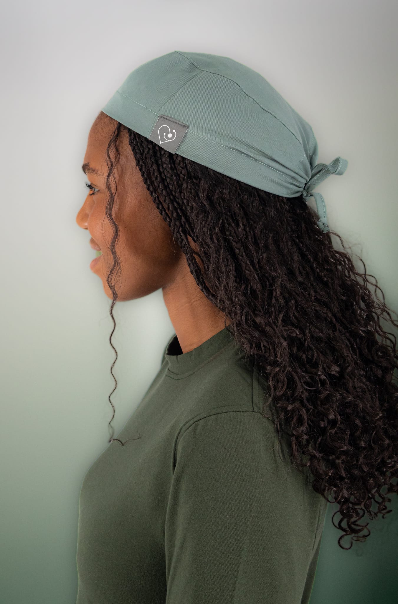 Student in a sage WiZ Scrub Cap Pro