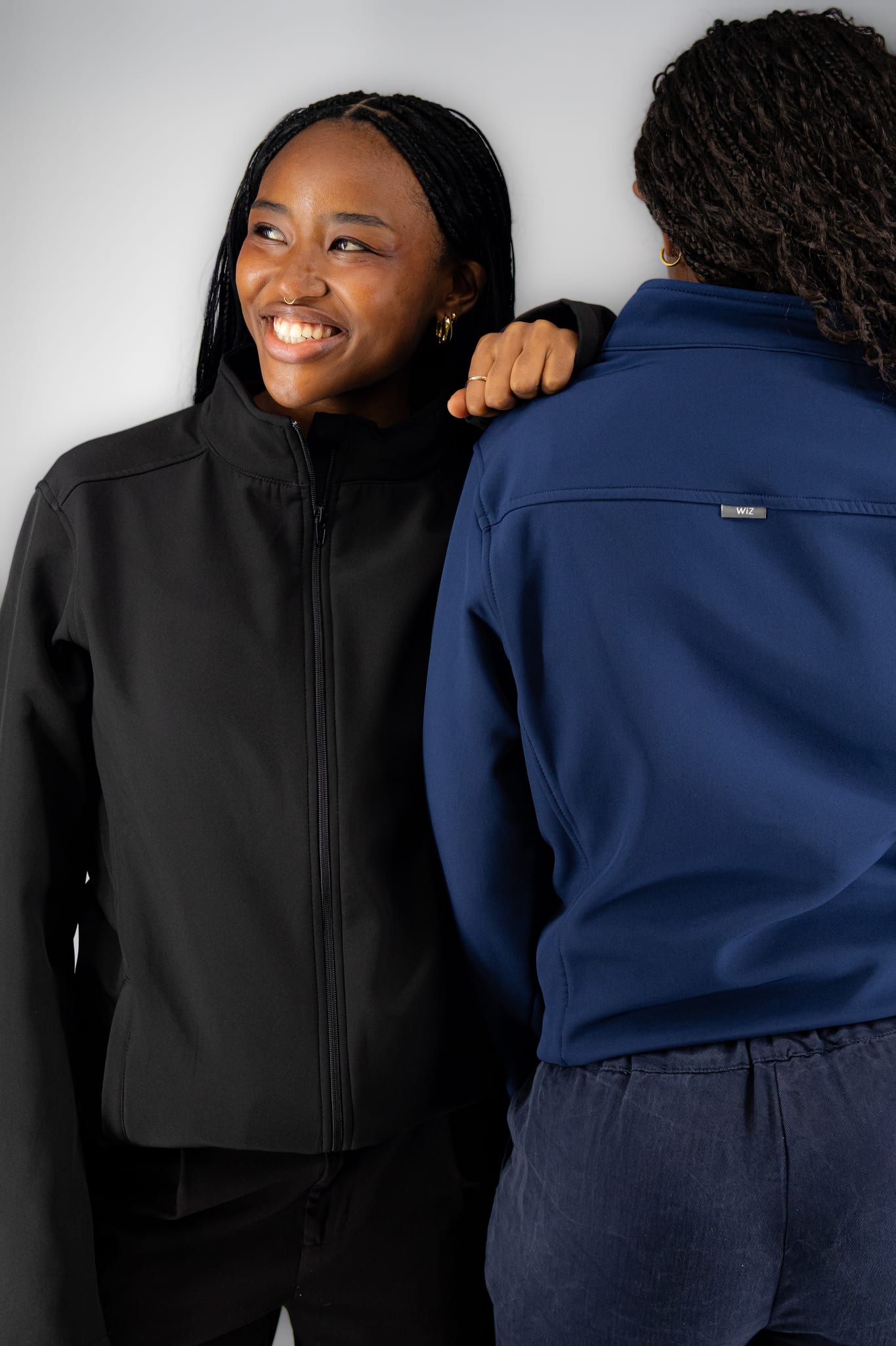 Two students in the black and navy WiZscrubs Comfort Jackets
