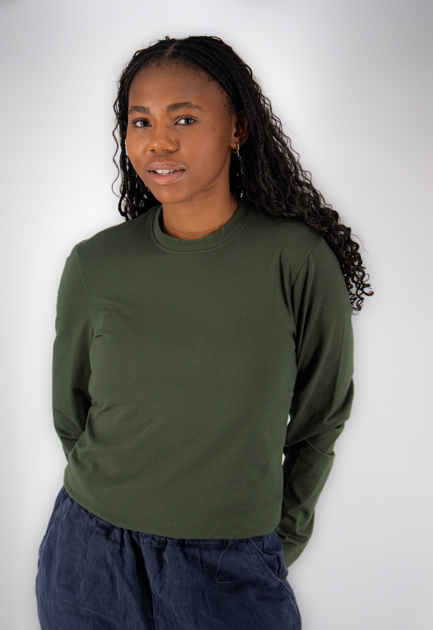 Woman wearing a bottle green long-sleeve underscrub