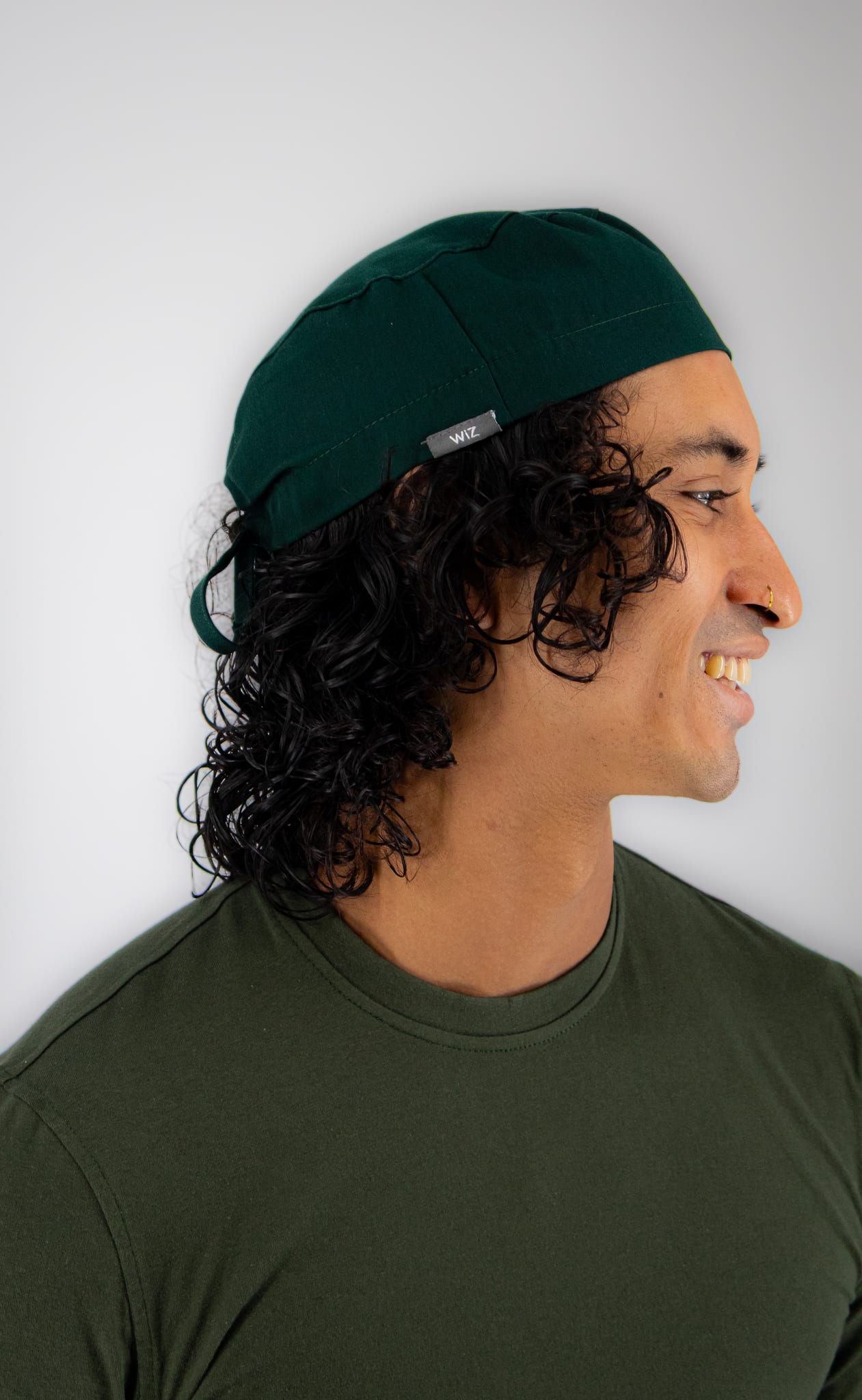 Student in a bottle green WiZ Scrub Cap Pro