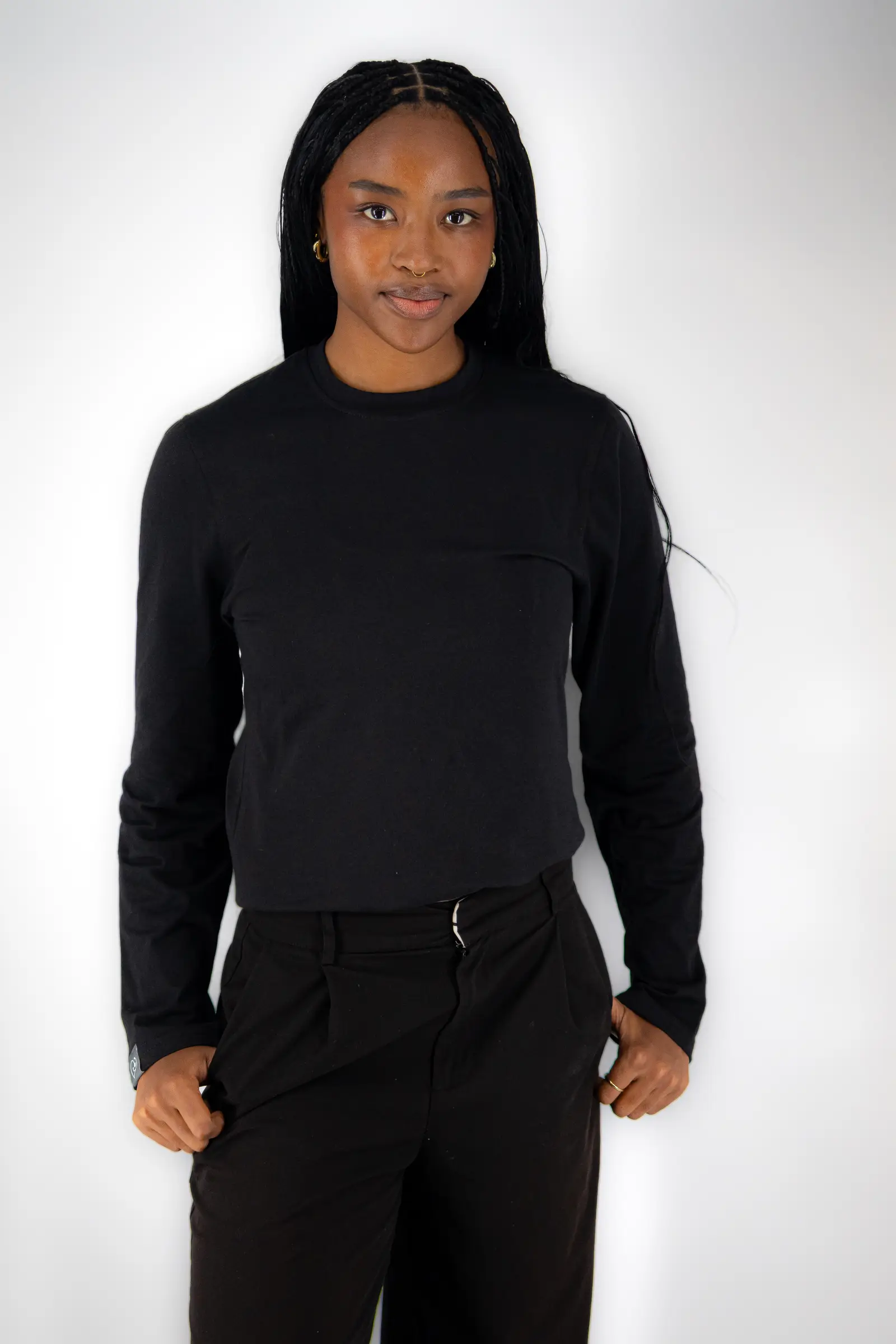 Women's long-sleeve underscrub in black, worn under scrubs